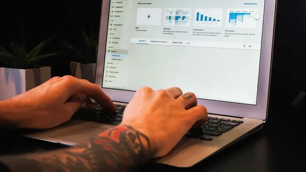 Person reviewing website analytics on a laptop at a desk.